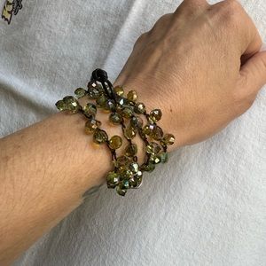 Lizou convertible crocheted wrap bracelet with green crystals.